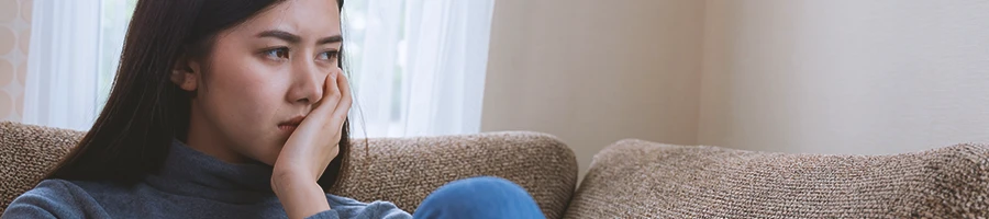 A woman with low testosterone, tired on a sofa