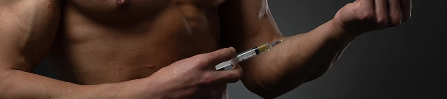 Man preparing syringe on his forearm