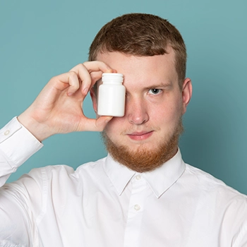 Holding a supplement container pills