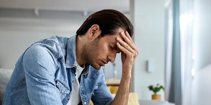 Man with low testosterone having a headache and anxiety