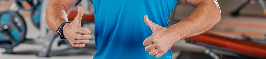 Muscular person giving two thumbs up