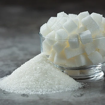 Sugar cubes in bowl and powder