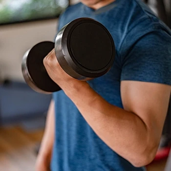 Lifting dumbbell close up image