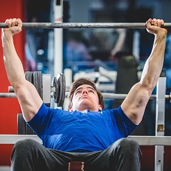 A guy performing bench press