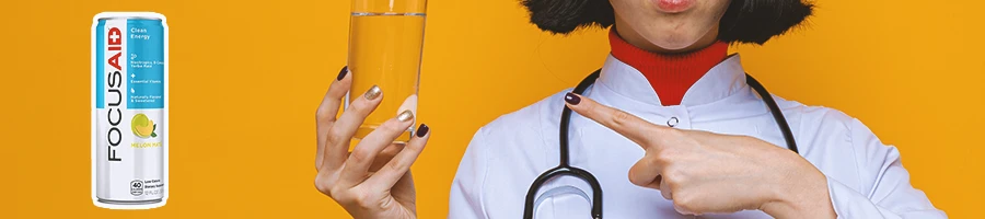 A doctor holding up a glass with Focus Aid on the side