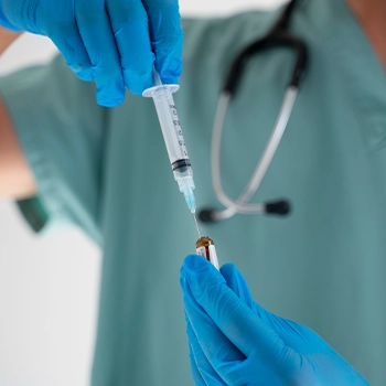 A doctor holding a syringe for a test