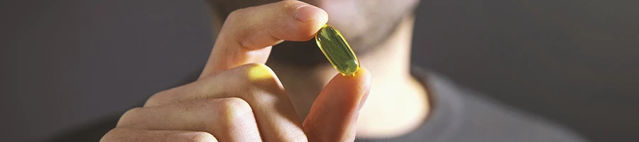 A person holding a saw palmetto pill