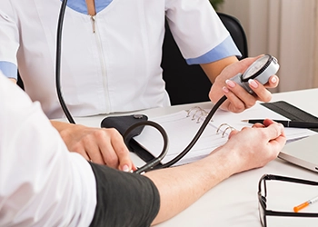 Doctor checking cholesterol and testosterone levels of patient