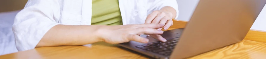 A woman using a laptop in the kitchen