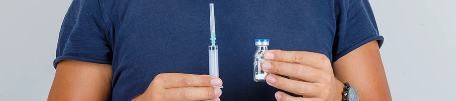 A syringe and a sample of vial