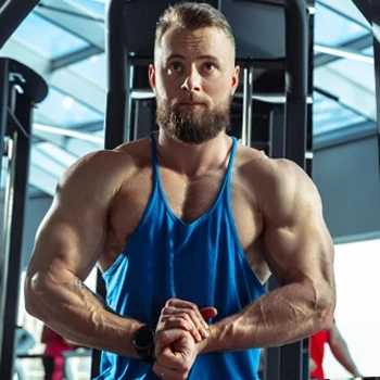 A muscular person looking at his reflection and flexing his muscles