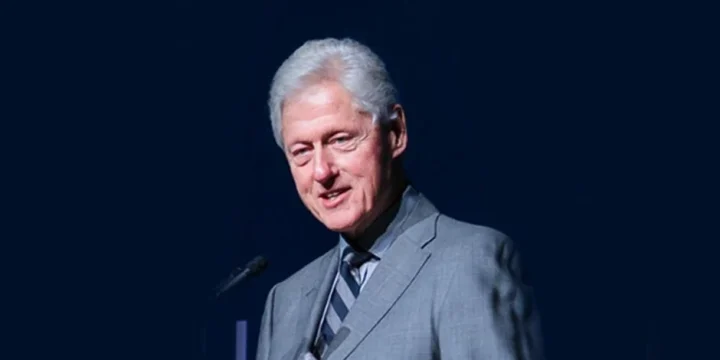 Bill Clinton having a speech in blue background