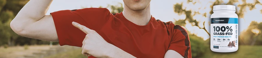 A buff male pointing to his biceps with Transparent Labs Protein Powder on the side