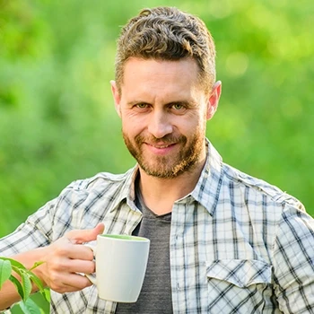 Man drinking tea outdoors