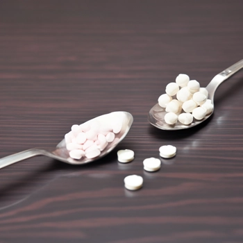 Supplement tablets on a spoon