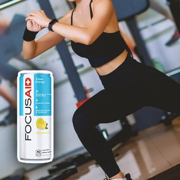 A woman stretching in a gym with Focus Aid on the foreground