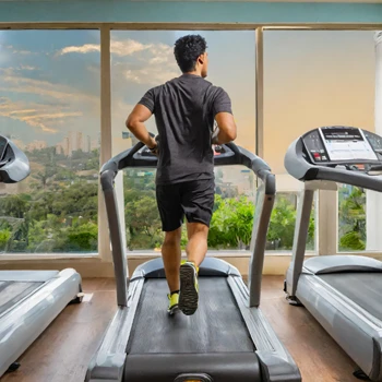 A guy using a treadmill in his workout