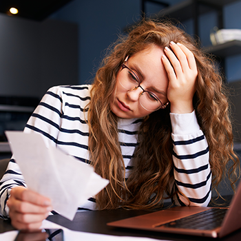 Stressed woman reading a paper