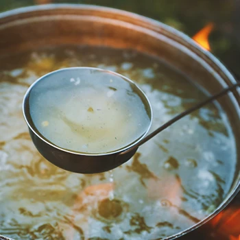 Close up shot of bone broth being boiled outside
