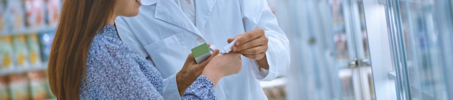 A doctor and a patient looking at nootropic pills at a store