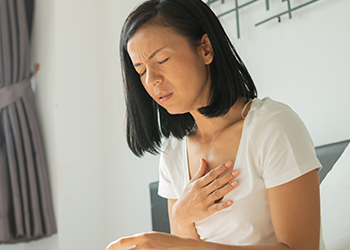 A person in bed having a problem with her heart rate