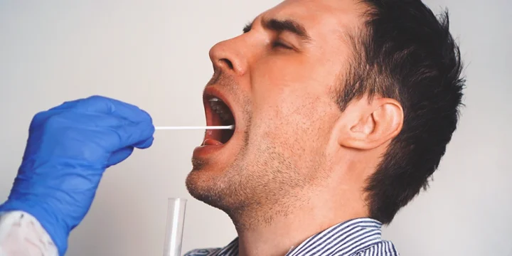 A doctor taking a saliva sample to check testosterone levels