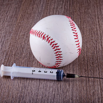 Baseball and syringe lying on the floor