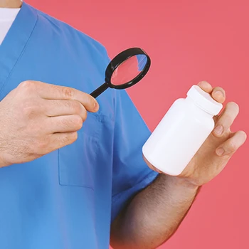 A nurse reading the label from a nootropic pill bottle