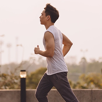 Asian man jogging outdoors