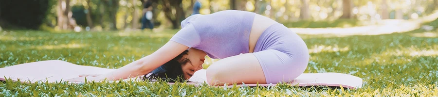 A woman stretching at a park outside