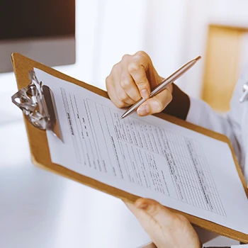 A doctor with a clipboard reading about low testosterone levels