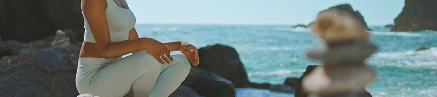 A woman relaxing and doing yoga outside using Quantamind