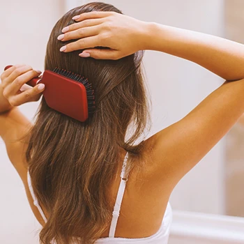 A woman brushing her long hair