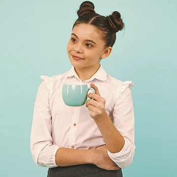 A child holding a cup of coffee