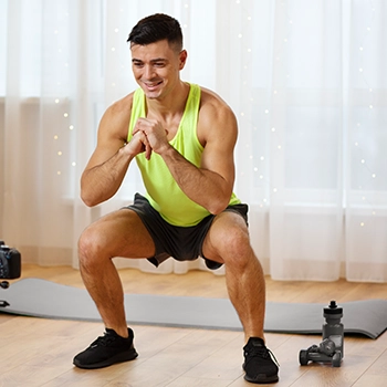 Performing squats inside his home