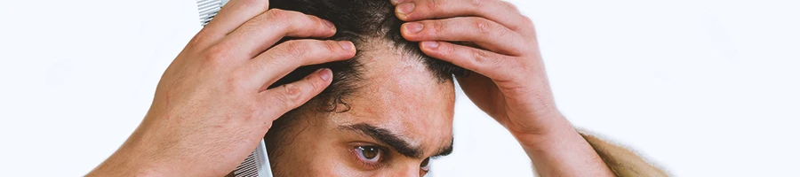 A man scared of hair loss checking his hair