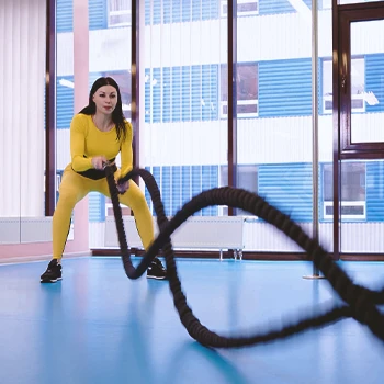 A woman doing HIIT with ropes