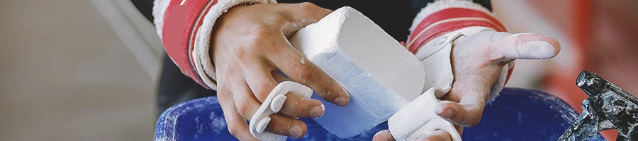 A person holding up a homemade gym chalk block