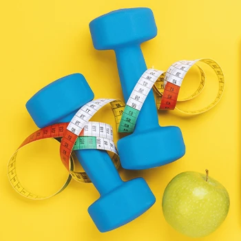 Close up shot of weights and an apple