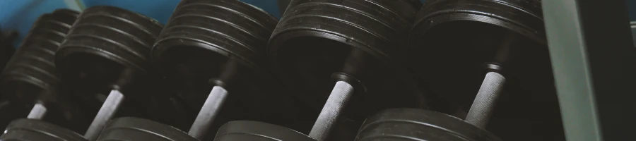 A bunch of dumbbells in a row