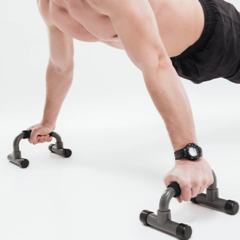 Performing an exercise using a push-up bar indoors