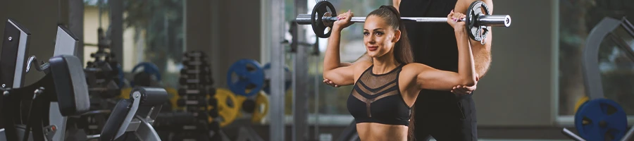 A woman lifting weights at the gym