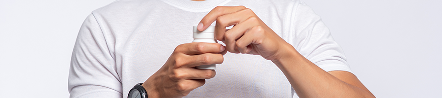 A man checking a supplement container