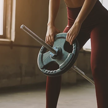 A woman working out with a T-Bar Row