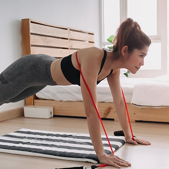 Doing a push up using a resistance band