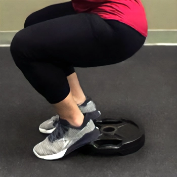 Doing heel elevated squat