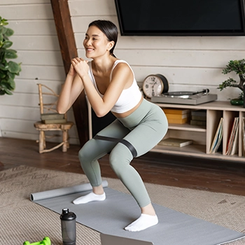 Performing squats at home using resistance band