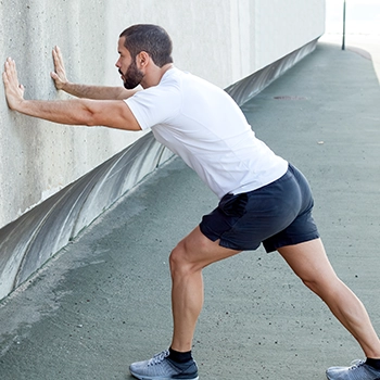 Doing standing calf stretch