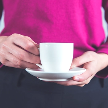 A woman holding a cup of coffee