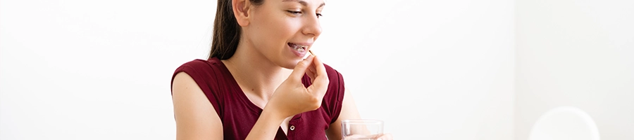 A woman drinking vitamins